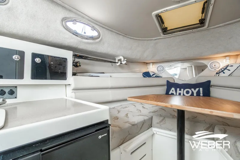 Slide: The Image of Interior of 2004 Hydra-Sports Vector 2800 WA boat with cozy seating and table. - 16