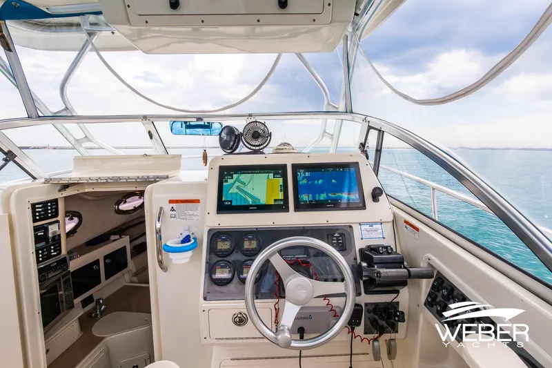 Slide: The Image of 2004 Hydra-Sports Vector 2800 WA boat cockpit with navigation screens and steering wheel. - 9