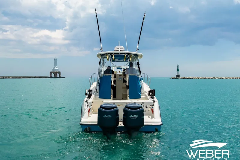 Slide: The Image of 2004 Hydra-Sports Vector 2800 WA boat on turquoise water near lighthouses. - 32