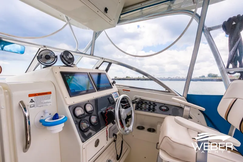 Slide: The Image of 2004 Hydra-Sports Vector 2800 WA boat cockpit with modern navigation equipment and comfortable seating. - 10