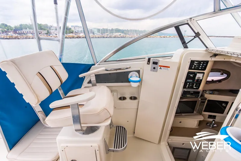 Slide: The Image of 2004 Hydra-Sports Vector 2800 WA boat interior with captain's chair and control panel. - 12