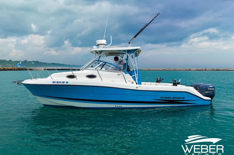 Slide: The Image of 2004 Hydra-Sports Vector 2800 WA boat on calm water under cloudy sky. - 4