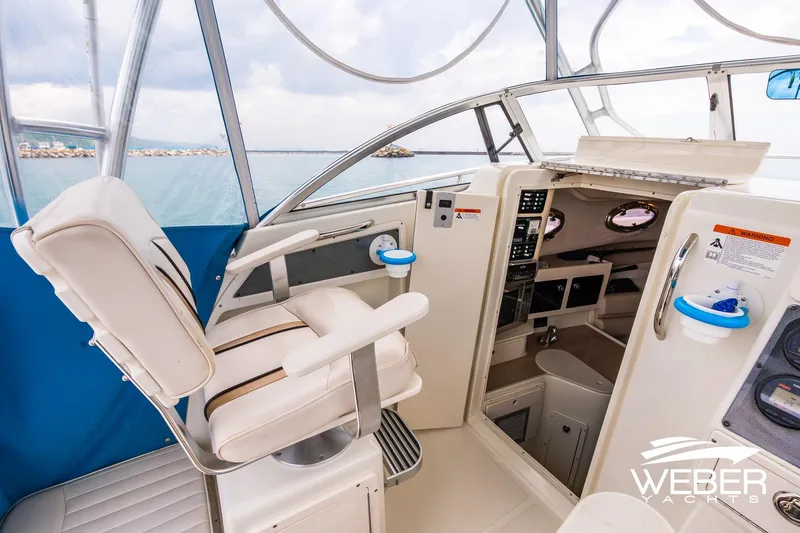 Slide: The Image of 2004 Hydra-Sports Vector 2800 WA boat interior with helm seat and cabin view. - 7