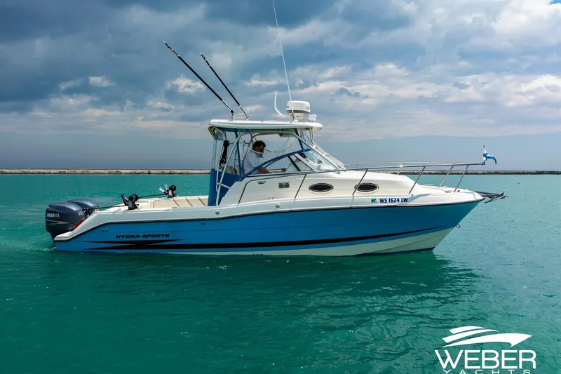 Slide: The Image of 2004 Hydra-Sports Vector 2800 WA boat on turquoise water under cloudy sky. - 3