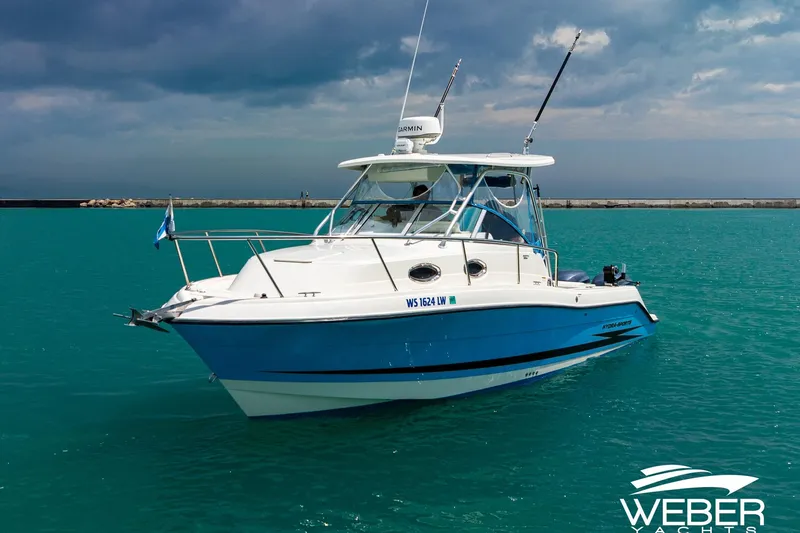 Slide: The Image of 2004 Hydra-Sports Vector 2800 WA boat on turquoise water under cloudy sky. - 25