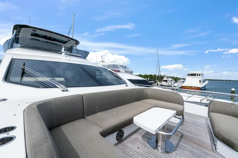 Slide: The Image of Luxurious 2020 Azimut Fly 78 yacht with elegant outdoor seating, docked at a marina. - 7
