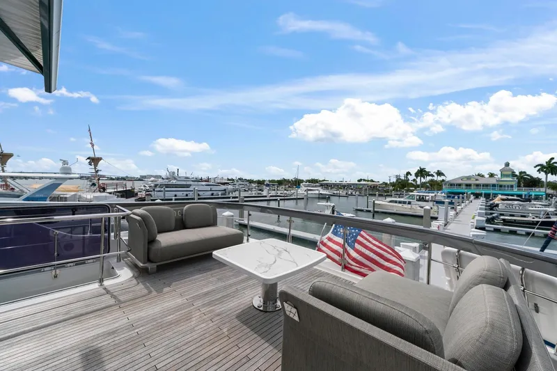 Slide: The Image of Luxurious 2020 Azimut Fly 78 yacht deck with elegant seating and marina view. - 32