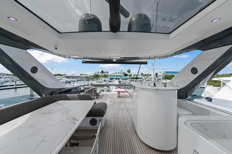 Slide: The Image of Luxurious 2020 Azimut Fly 78 yacht deck with elegant seating and marina view. - 27