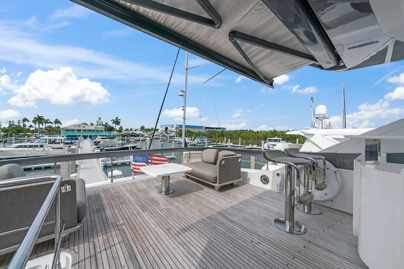 Slide: The Image of Luxurious 2020 Azimut Fly 78 yacht deck with seating, docked at marina under blue sky. - 30
