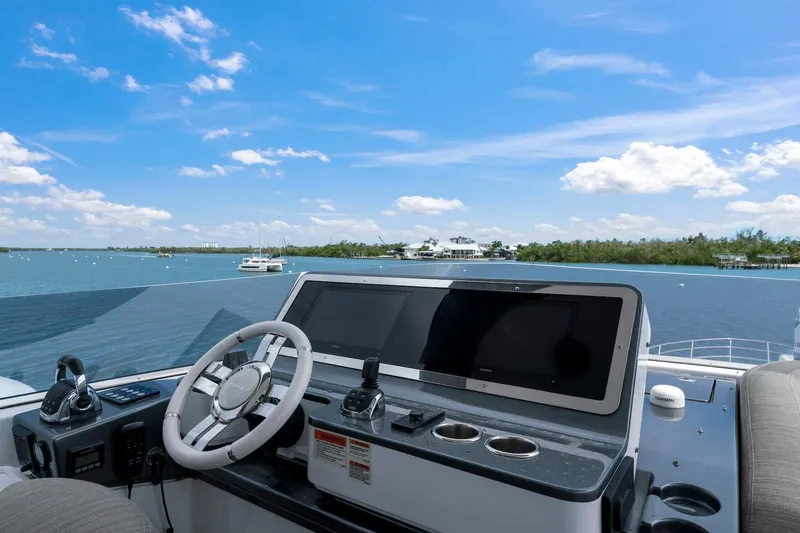 Slide: The Image of Cockpit view of 2020 Azimut Fly 78 yacht with scenic ocean backdrop. - 43