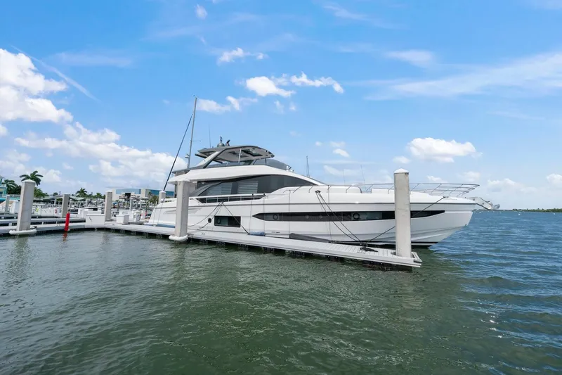 Slide: The Image of Luxury Azimut Fly 78 yacht docked at marina, 2020 model, under clear blue sky. - 21