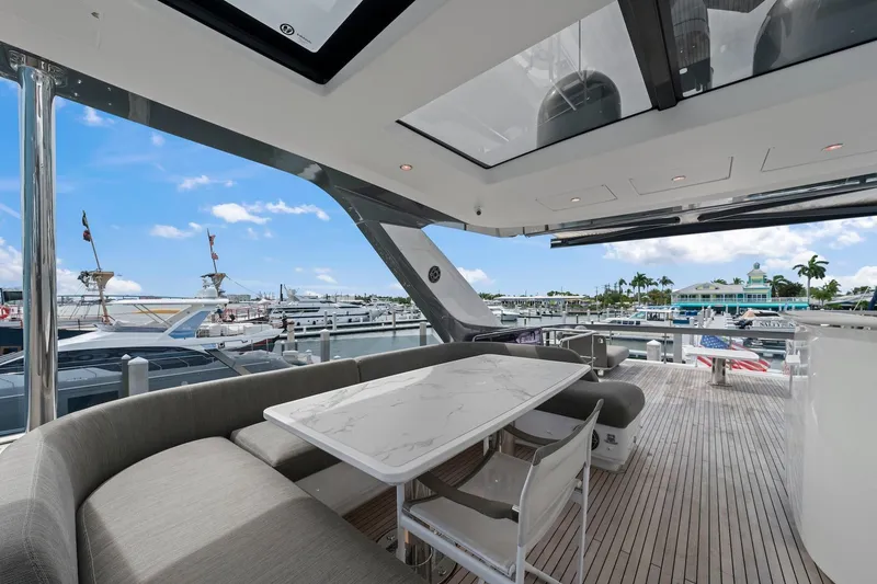 Slide: The Image of Luxurious 2020 Azimut Fly 78 yacht deck with elegant seating and marina view. - 28