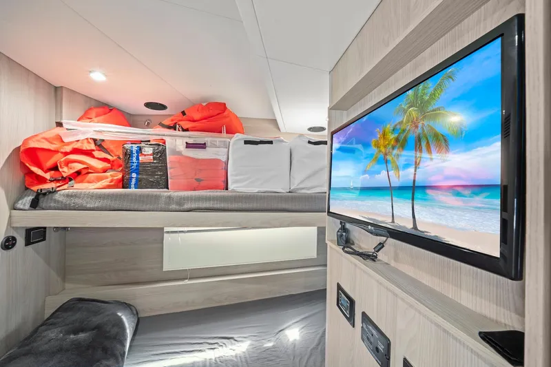 Slide: The Image of Interior of 2020 Azimut Fly 78 yacht cabin with TV, bunk, and life jackets. - 13