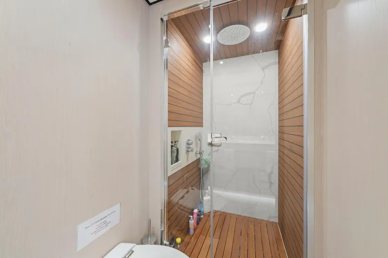 Slide: The Image of Luxurious shower in 2020 Azimut Fly 78 yacht with wood accents and modern fixtures. - 80