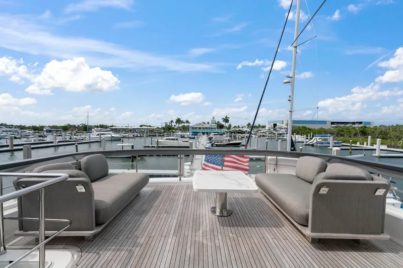 Slide: The Image of Luxurious 2020 Azimut Fly 78 yacht deck with elegant seating and marina view. - 31