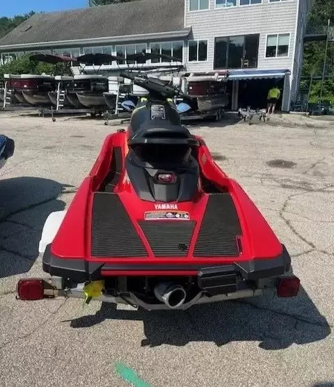 Slide: The Image of A red 2024 Waverunner EX DELUXE is parked on a lot in front of a building. - 3