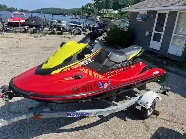 Slide: The Image of A red 2024 Waverunner EX DELUXE on a trailer, parked near a lakeside. - 7