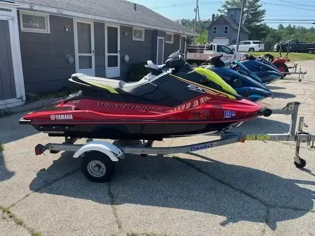 Slide: The Image of A row of jet skis, including a red 2024 Waverunner EX DELUXE, on a trailer. - 1
