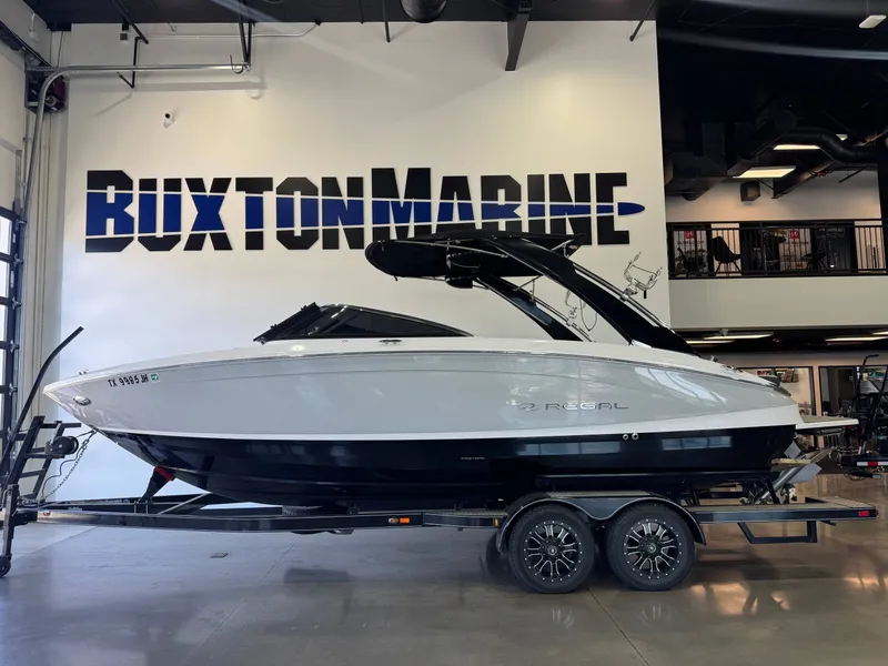 Slide: The Image of A 2020 Regal LS6 Surf boat on a trailer in a showroom. - 4