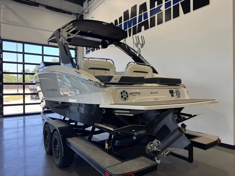 Slide: The Image of A 2020 Regal LS6 Surf boat on a trailer in a showroom. - 5