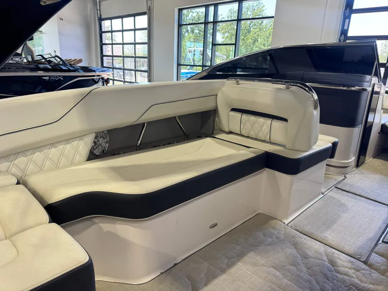 Slide: The Image of Interior of a 2020 Regal LS6 Surf with sleek white upholstery and black accents. - 14