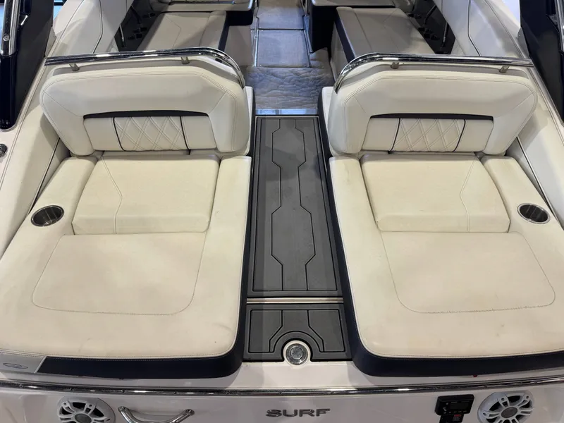 Slide: The Image of The image shows the stern of a 2020 Regal LS6 Surf boat with white upholstery. - 10