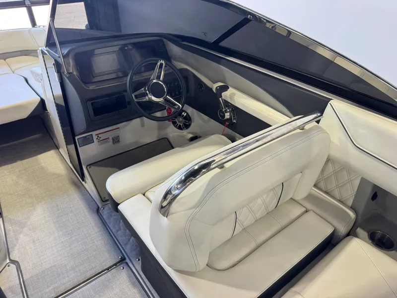 Slide: The Image of The image shows the cockpit of a 2020 Regal LS6 Surf with white leather seats and a modern dashboard. - 23