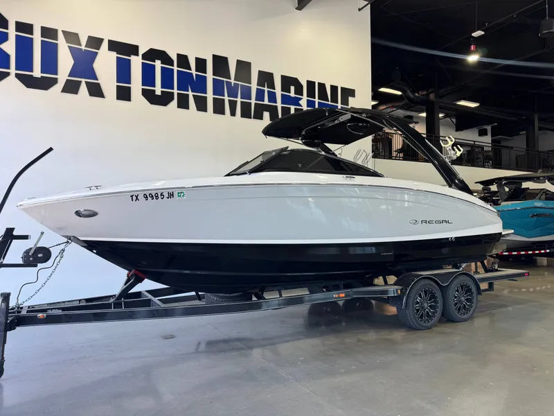 Slide: The Image of 2020 Regal LS6 Surf boat on a trailer in a showroom. - 3