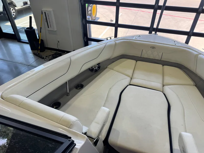 Slide: The Image of The image shows the bow area of a 2020 Regal LS6 Surf boat with white upholstery. - 19