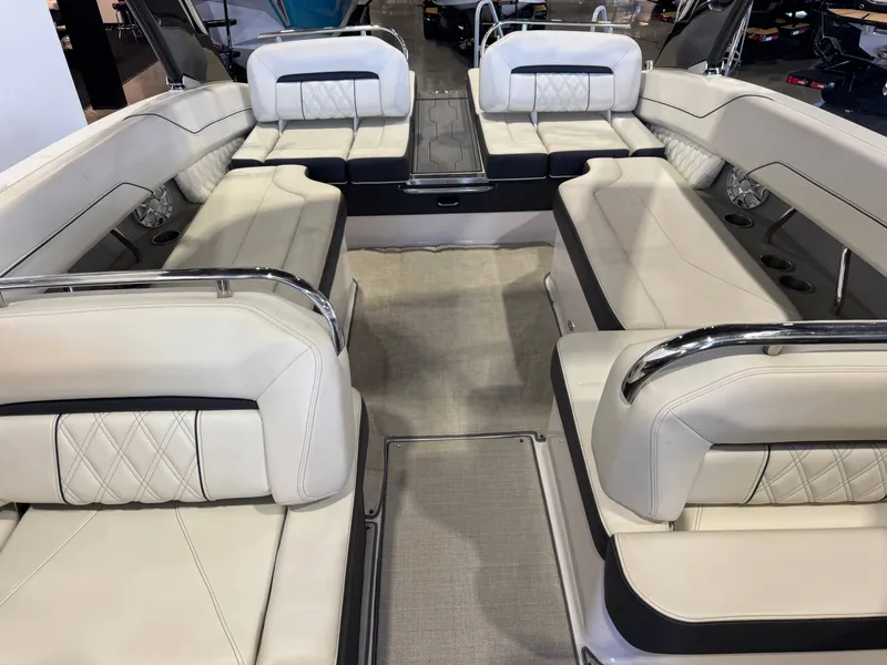 Slide: The Image of Interior view of a 2020 Regal LS6 Surf boat with luxurious cream-colored upholstered seating. - 21