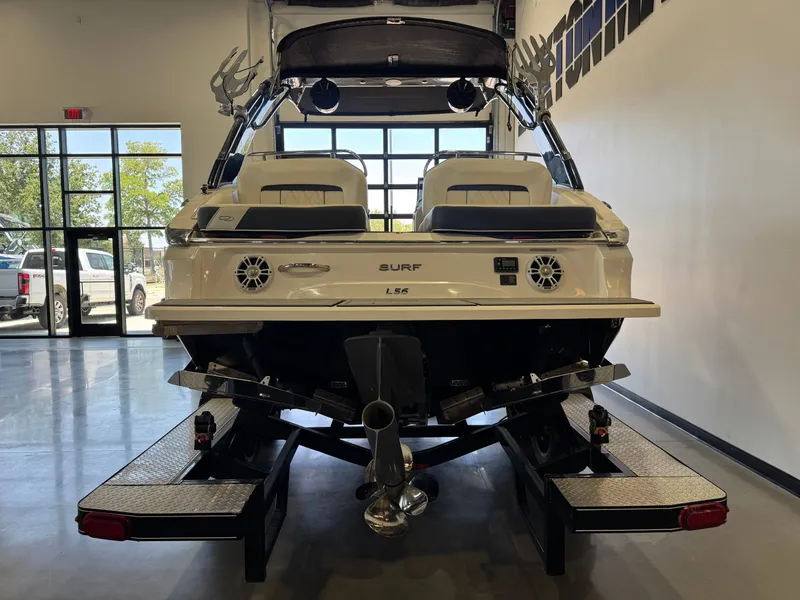 Slide: The Image of A 2020 Regal LS6 Surf boat is on a trailer in a showroom. - 6
