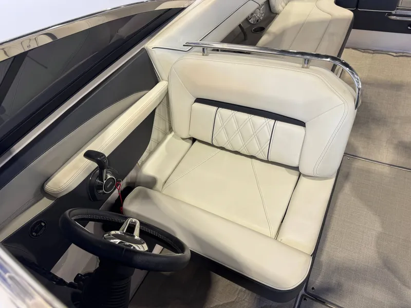 Slide: The Image of Interior of a 2020 Regal LS6 Surf with cream leather seats and a black steering wheel. - 20