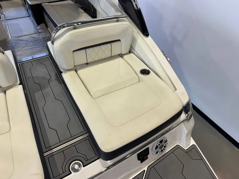 Slide: The Image of The image shows the rear of a 2020 Regal LS6 Surf boat with beige upholstery and black accents. - 11