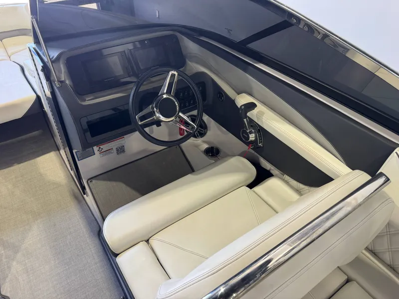 Slide: The Image of The image shows the cockpit of a 2020 Regal LS6 Surf boat with a sleek steering wheel and modern instruments. - 24