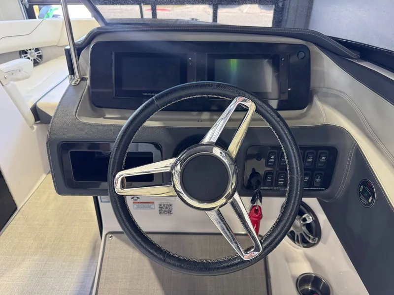 Slide: The Image of The image shows the helm of a 2020 Regal LS6 Surf boat with modern instruments. - 25
