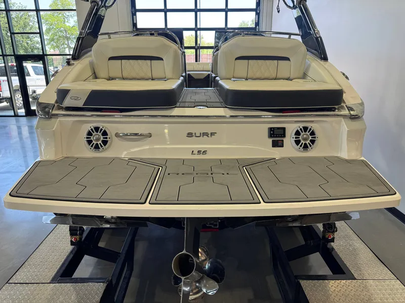 Slide: The Image of The image shows the rear of a 2020 Regal LS6 Surf boat with cushioned seating. - 8