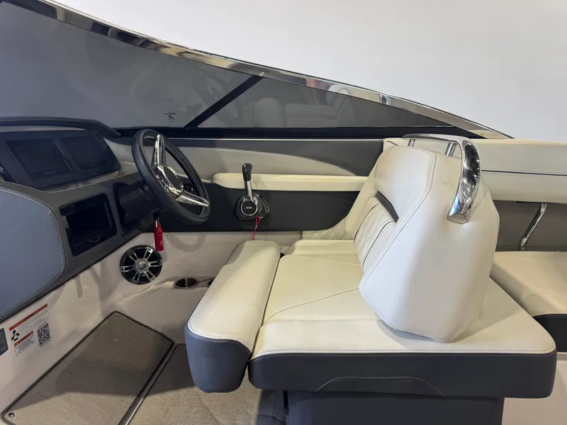 Slide: The Image of The image shows the cockpit of a 2020 Regal LS6 Surf boat with sleek seating and a modern steering wheel. - 22
