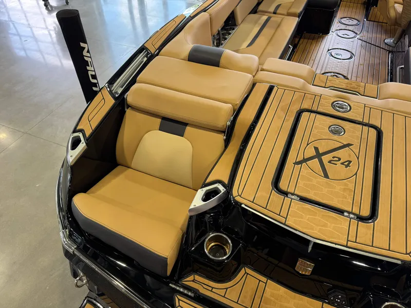 Slide: The Image of The image shows the luxurious interior of a MasterCraft X24 boat with sleek seating and wood accents. - 12