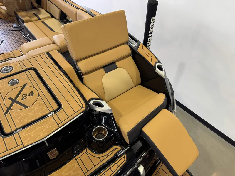 Slide: The Image of The image shows the luxurious interior of a MasterCraft X24 boat with beige upholstery. - 13