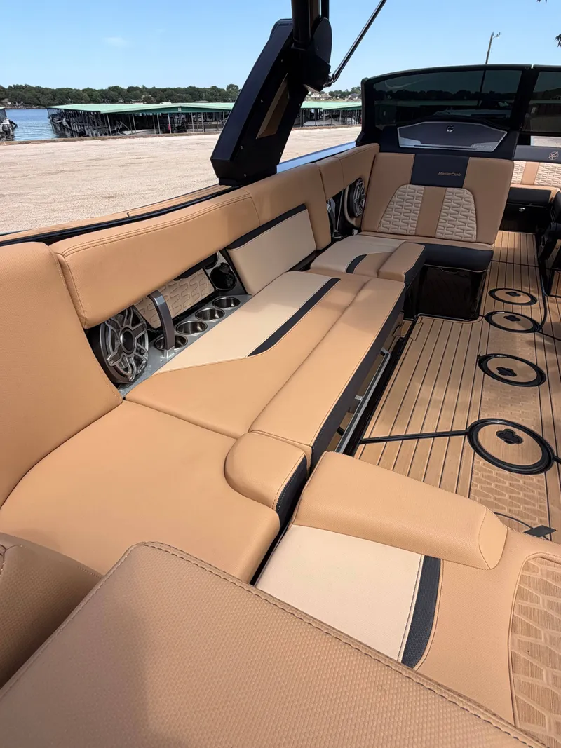 Slide: The Image of The image shows the interior of a 2025 MasterCraft X24 boat with beige upholstery. - 6