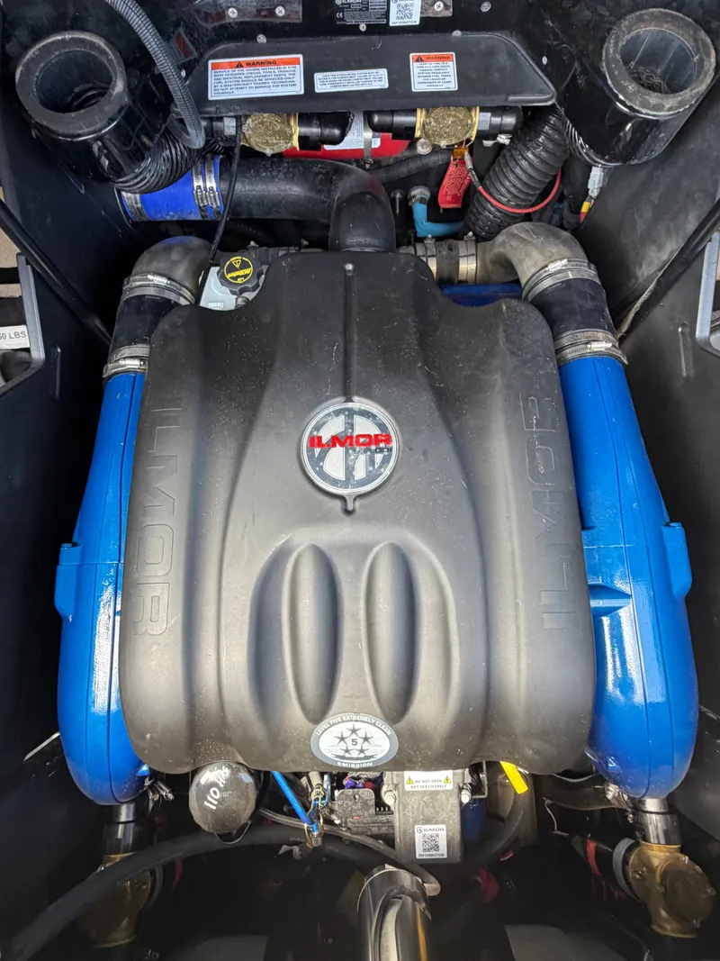Slide: The Image of The engine compartment of a 2025 MasterCraft X24 features a powerful Ilmor engine with blue components. - 18