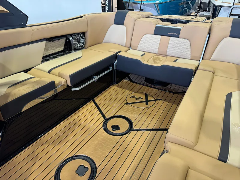 Slide: The Image of The image shows the luxurious interior of a MasterCraft X24 boat with beige upholstery and wood flooring. - 17