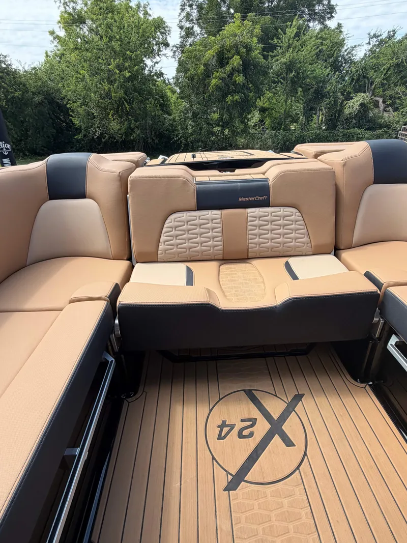 Slide: The Image of The image shows the luxurious interior of a 2025 MasterCraft X24 with beige upholstery. - 17