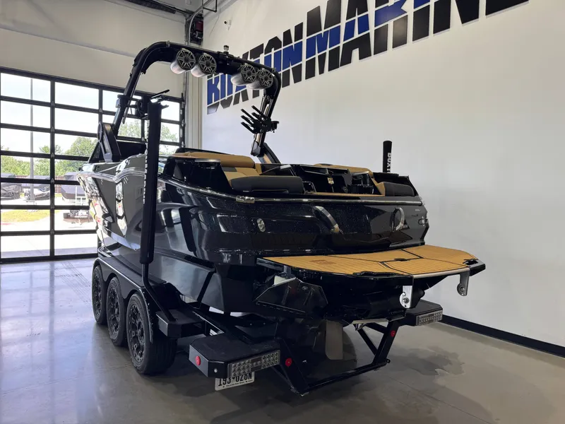 Slide: The Image of A 2025 MasterCraft X24 in a showroom. It features a sleek black design. - 5