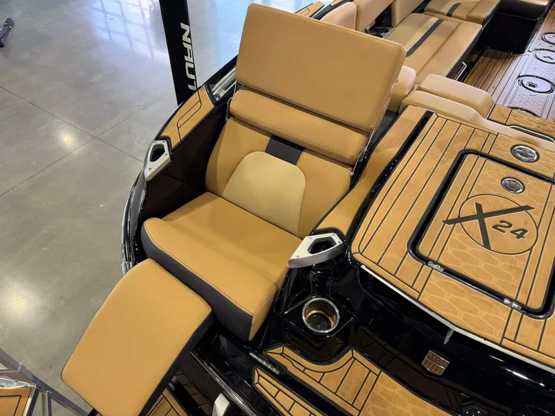 Slide: The Image of The image shows the luxurious interior of a 2025 MasterCraft X24 with beige upholstery. - 14