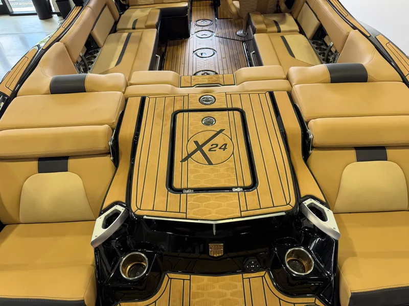 Slide: The Image of The image shows the luxurious interior of a MasterCraft X24 boat with elegant beige upholstery. - 10