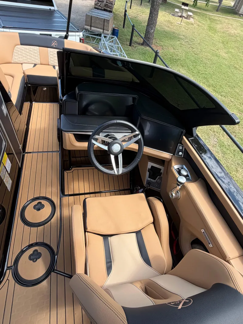 Slide: The Image of The image shows the cockpit of a 2025 MasterCraft X24 with sleek seating and a modern steering wheel. - 15