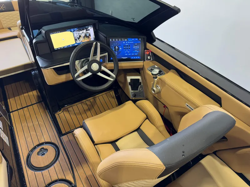 Slide: The Image of The image shows the cockpit of a 2025 MasterCraft X24 with modern instruments and leather seating. - 27