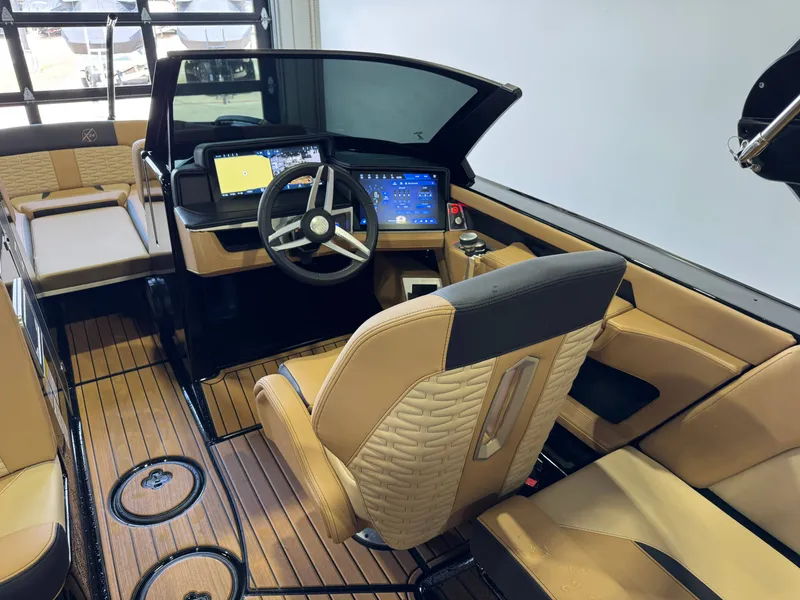 Slide: The Image of The image shows the cockpit of a 2025 MasterCraft X24 boat with modern instruments and leather seats. - 26