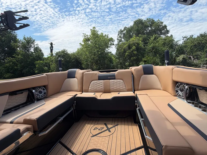 Slide: The Image of The image shows the luxurious cockpit of a 2025 MasterCraft X24 with beige upholstery. - 9